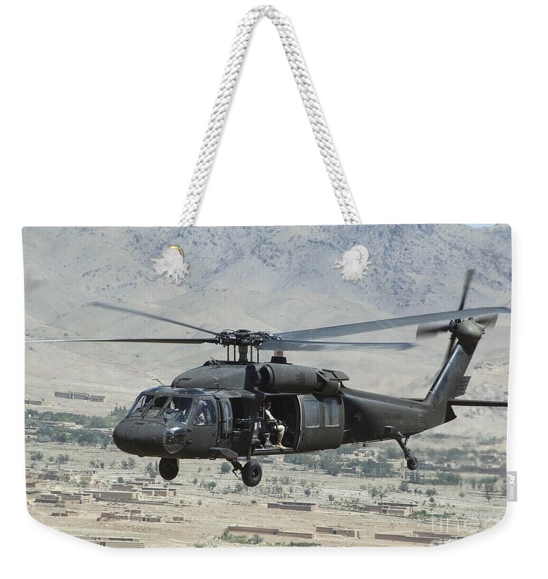 Horizontal Weekender Tote Bag featuring the photograph A Uh-60 Blackhawk Helicopter by Stocktrek Images