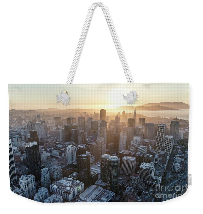 San Francisco Weekender Tote Bag featuring the photograph Aerial of downtown district at sunset, San Francisco, California by Matteo Colombo