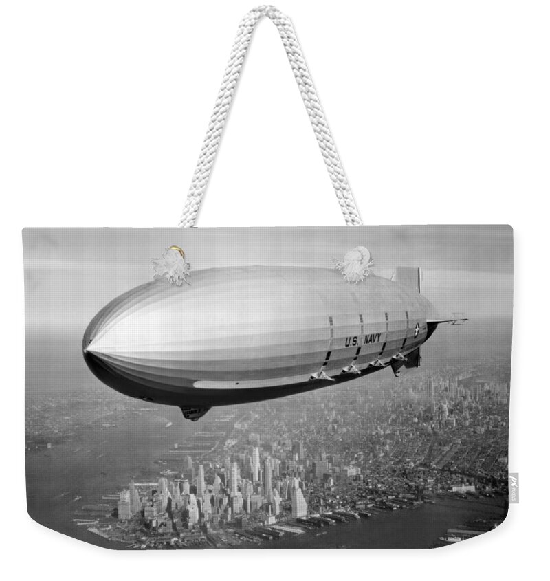 Uss Macon Weekender Tote Bag featuring the photograph Airship Flying Over New York City by War Is Hell Store