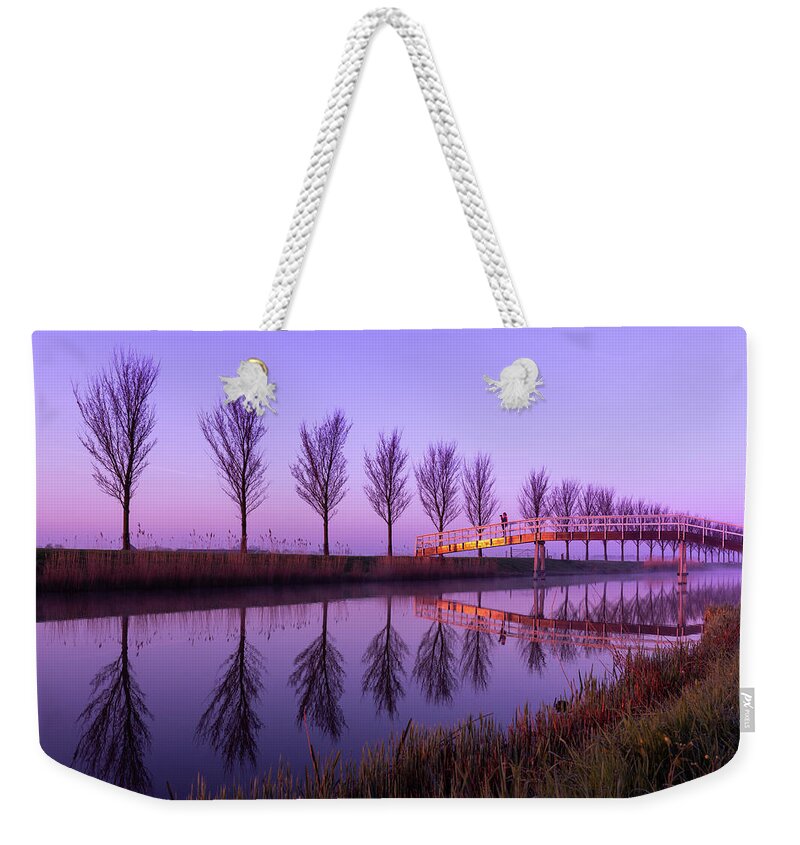 Bridge Weekender Tote Bag featuring the photograph Alone on a Canal Bridge by Sue Leonard