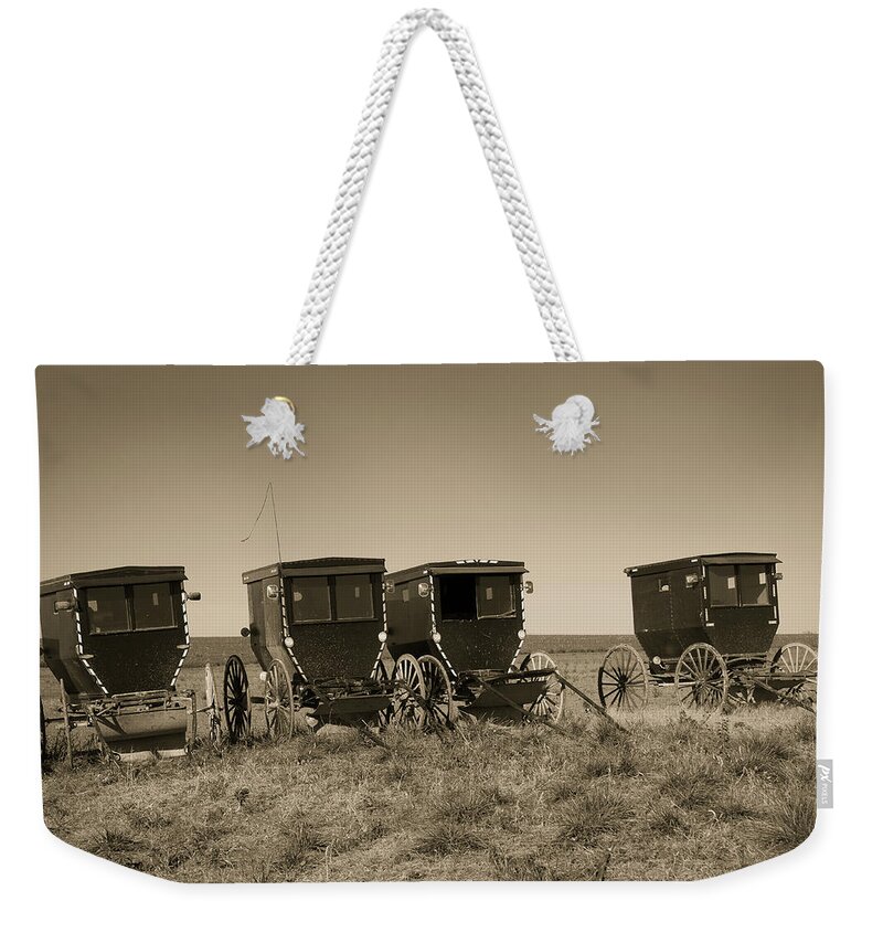 Steven Bateson Weekender Tote Bag featuring the photograph Amish Buggies by Steven Bateson