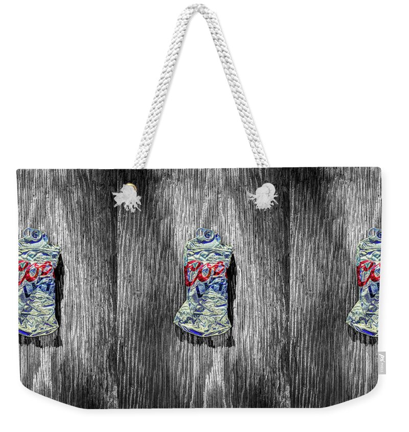Black Weekender Tote Bag featuring the photograph Crushed Silver Light Beer Can on BW Plywood 80 by YoPedro