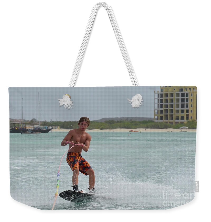 Wakeboard Weekender Tote Bag featuring the photograph Athletic Wakeboarder Riding a Wakeboard off the Coast of Aruba by DejaVu Designs