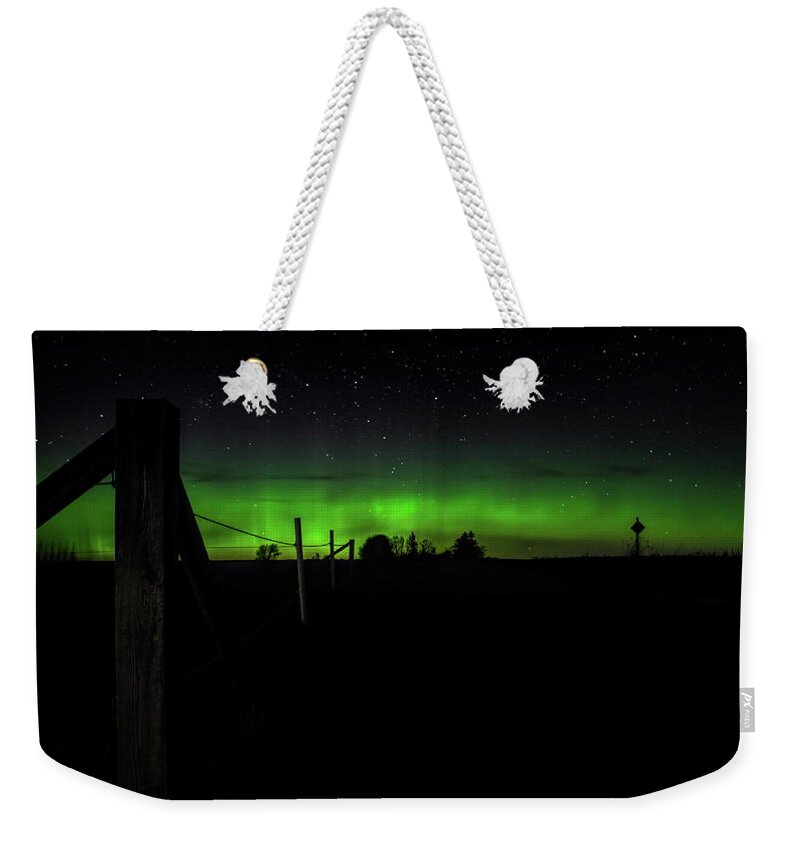 Aurora Borealis Weekender Tote Bag featuring the photograph Aurora At The Corner Post by Dale Kauzlaric
