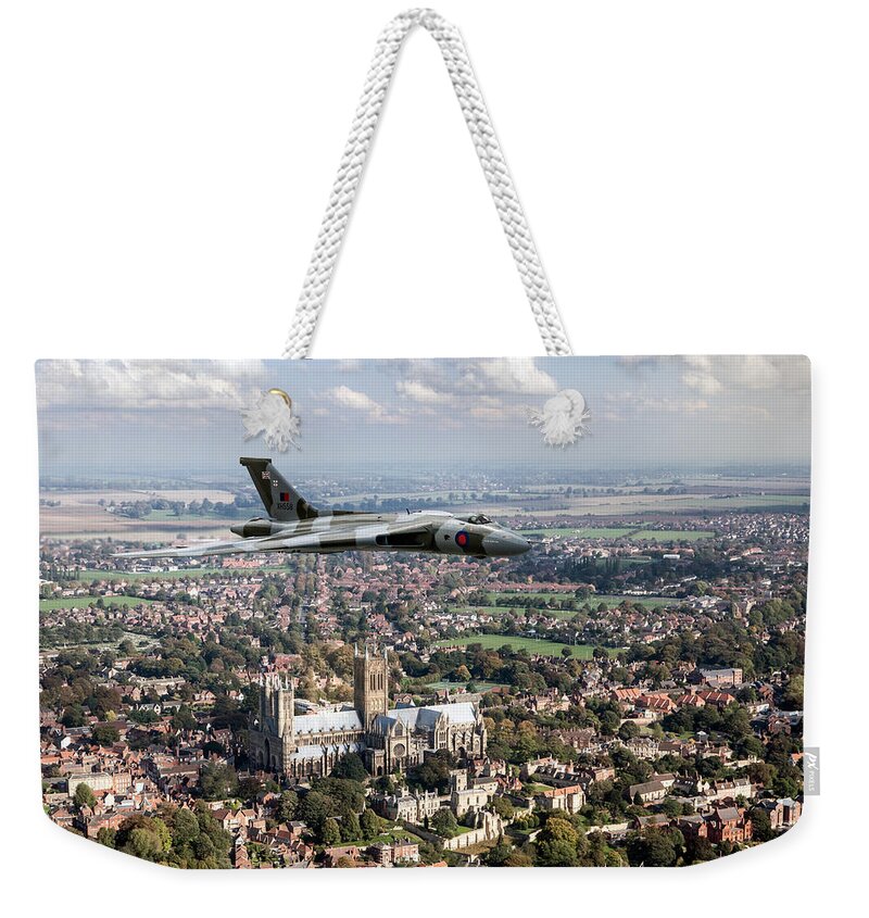 Raf Vulcan Bomber Weekender Tote Bag featuring the photograph Avro Vulcan passing Lincoln Cathedral by Gary Eason
