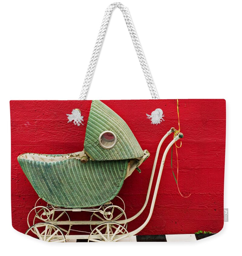 Baby Buggy Weekender Tote Bag featuring the photograph Baby buggy with red wall by Garry Gay