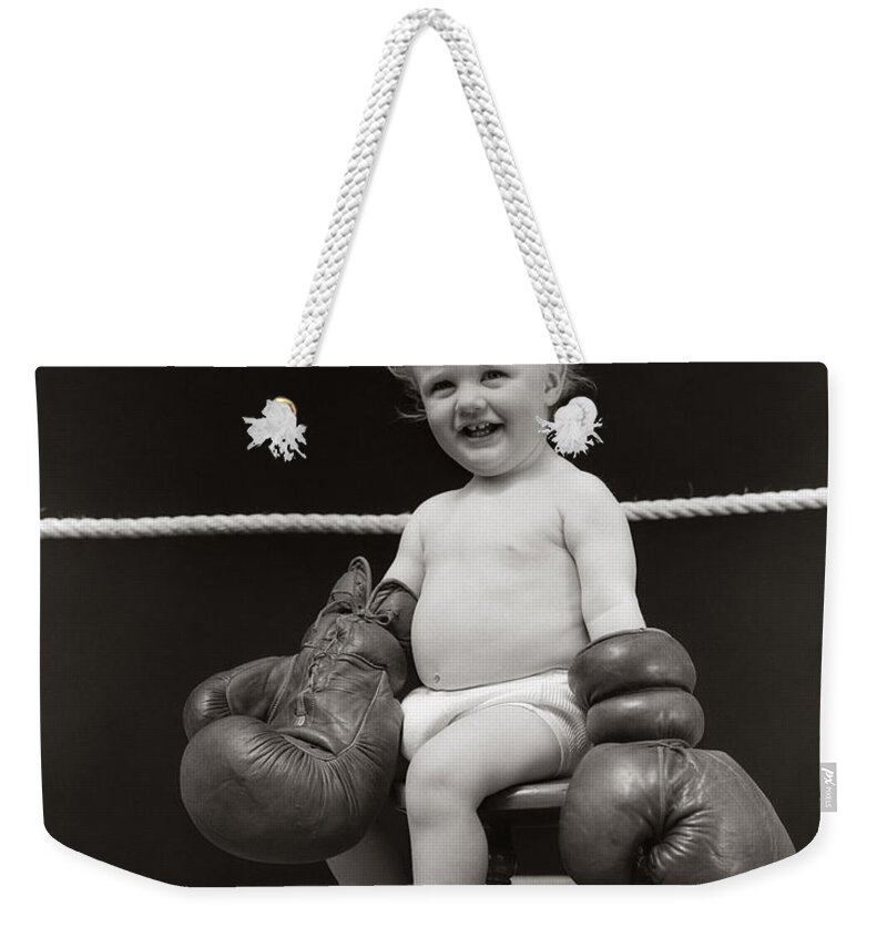 1930s Weekender Tote Bag featuring the photograph Baby In Boxing Gloves, C. 1930s by H. Armstrong Roberts/ClassicStock
