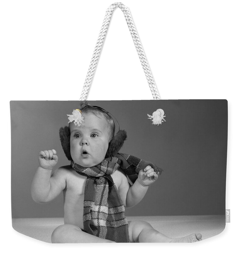 1960s Weekender Tote Bag featuring the photograph Baby In Scarf And Earmuffs, C.1960s by H Armstrong Roberts and ClassicStock