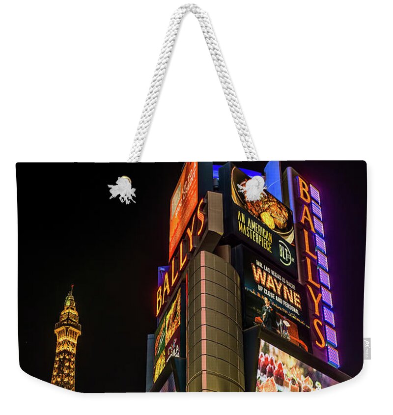 Ballys Casino Weekender Tote Bag featuring the photograph Ballys Sign in Front of the Eiffel Tower at Night by Aloha Art
