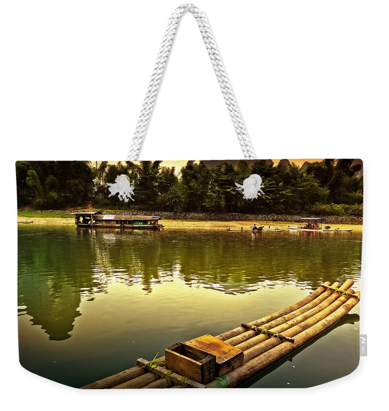 Sunset Weekender Tote Bag featuring the photograph Bamboo raft preparing to cross the river-China Guilin scenery Lijiang River in Yangshuo by Artto Pan