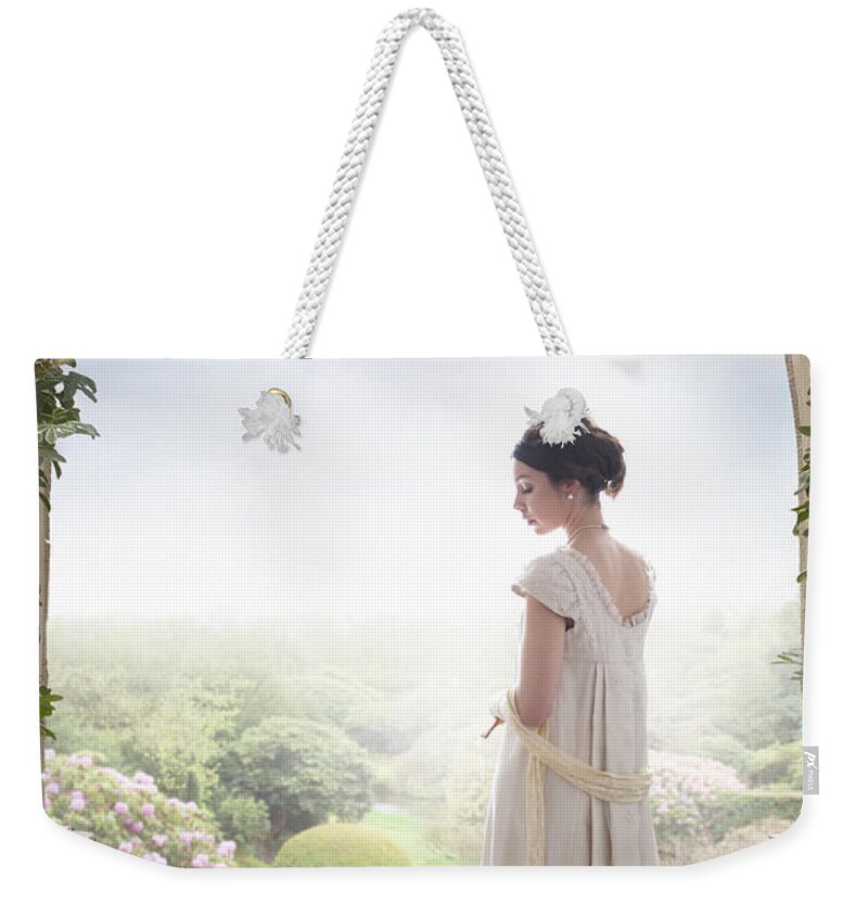 Regency Weekender Tote Bag featuring the photograph Beautiful Regency Woman Beneath A Wisteria Arch by Lee Avison