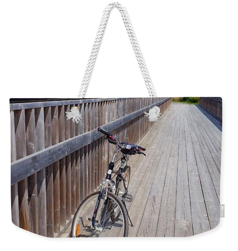 Bicycle Weekender Tote Bag featuring the photograph Bicycle on Bridge by Lucie Dumas
