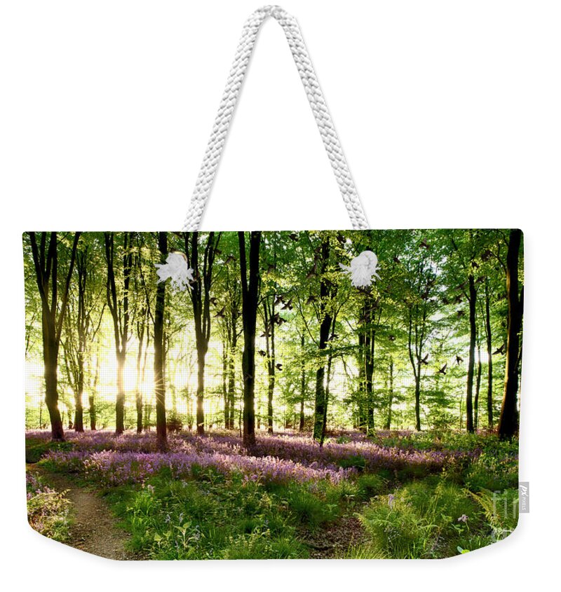 Bluebells Weekender Tote Bag featuring the photograph Birds flying though bluebell wood by Simon Bratt