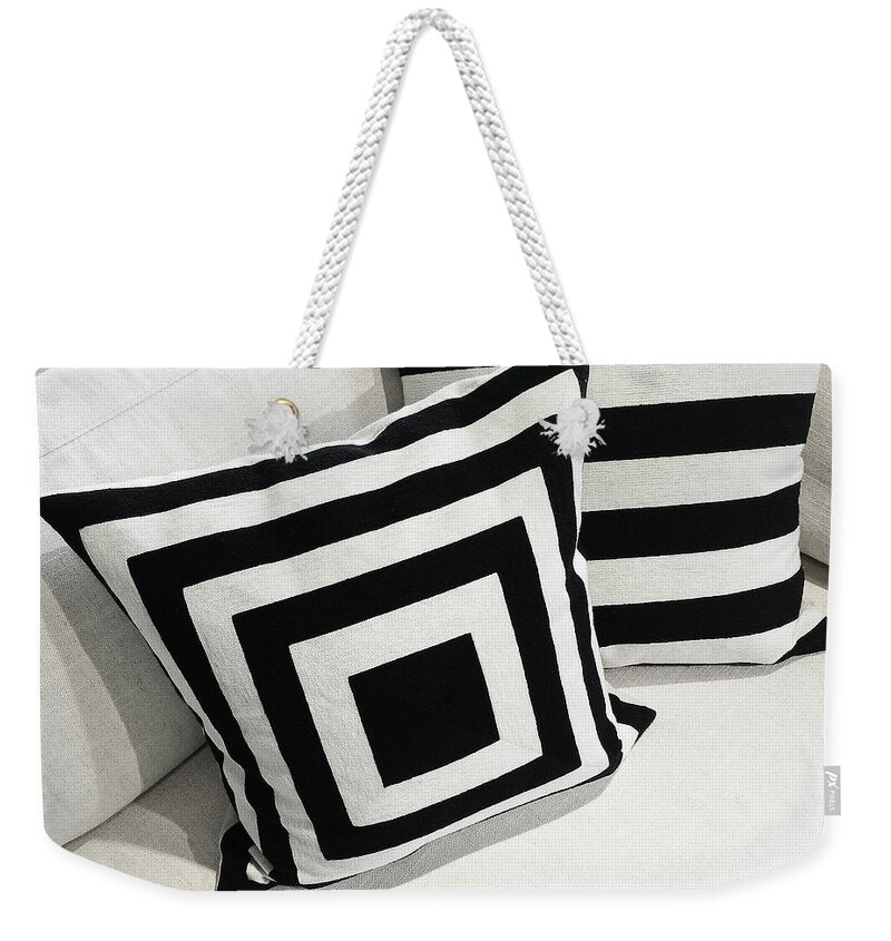 Sofa Weekender Tote Bag featuring the photograph Black and white cushions on a sofa by GoodMood Art