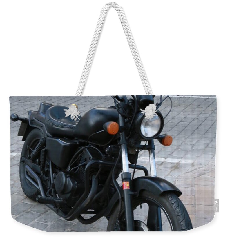Black Matte Bobber On The Street In Playa Del Ingles Weekender Tote Bag featuring the photograph Black Matte Bobber by John Siron