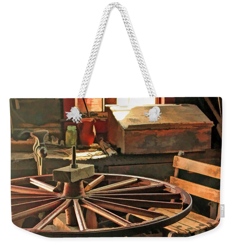 Old World Wisconsin Weekender Tote Bag featuring the painting Blacksmith Shop Wheel Repair at Old World Wisconsin by Christopher Arndt