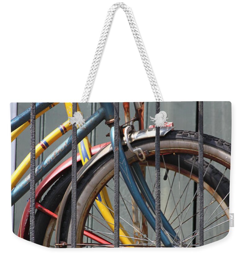 Bike Weekender Tote Bag featuring the photograph Blue and Yellow Bikes by Lauri Novak