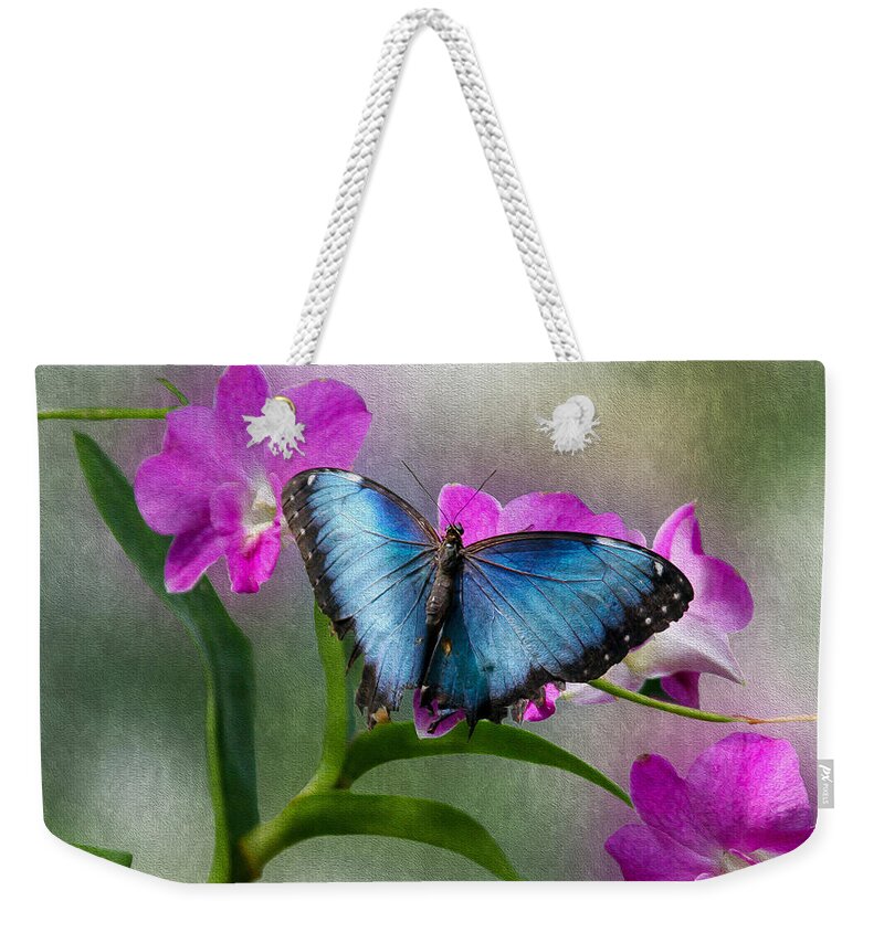 Bonnie Follett Weekender Tote Bag featuring the photograph Blue Morpho with orchids by Bonnie Follett