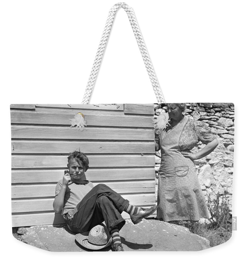 1940s Weekender Tote Bag featuring the photograph Boy Caught Smoking Pipe, C.1940s by H. Armstrong Roberts/ClassicStock