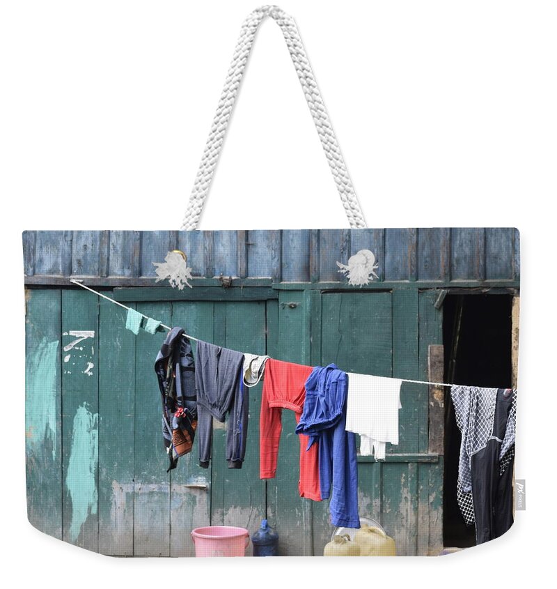 Clothes Weekender Tote Bag featuring the photograph By the rope by Sumit Mehndiratta