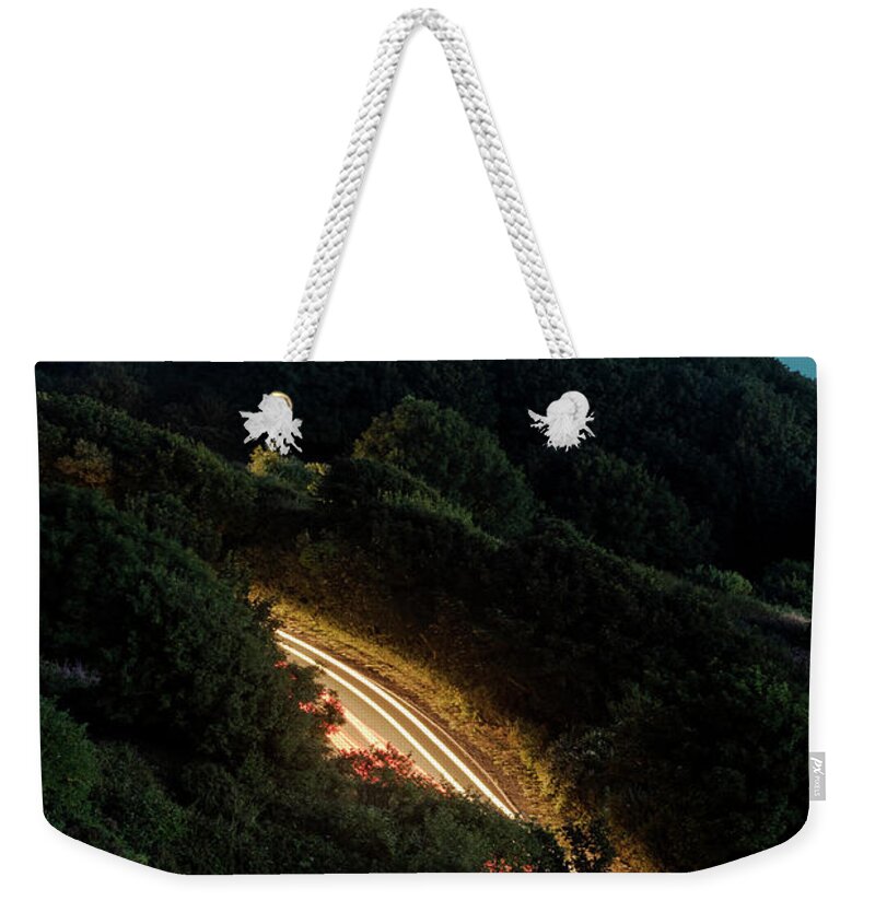 Clayton Weekender Tote Bag featuring the photograph Car Lights on country road by Clayton Bastiani