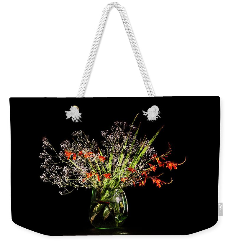 Baby's Breath Weekender Tote Bag featuring the photograph Cascade of white and orange. by Torbjorn Swenelius