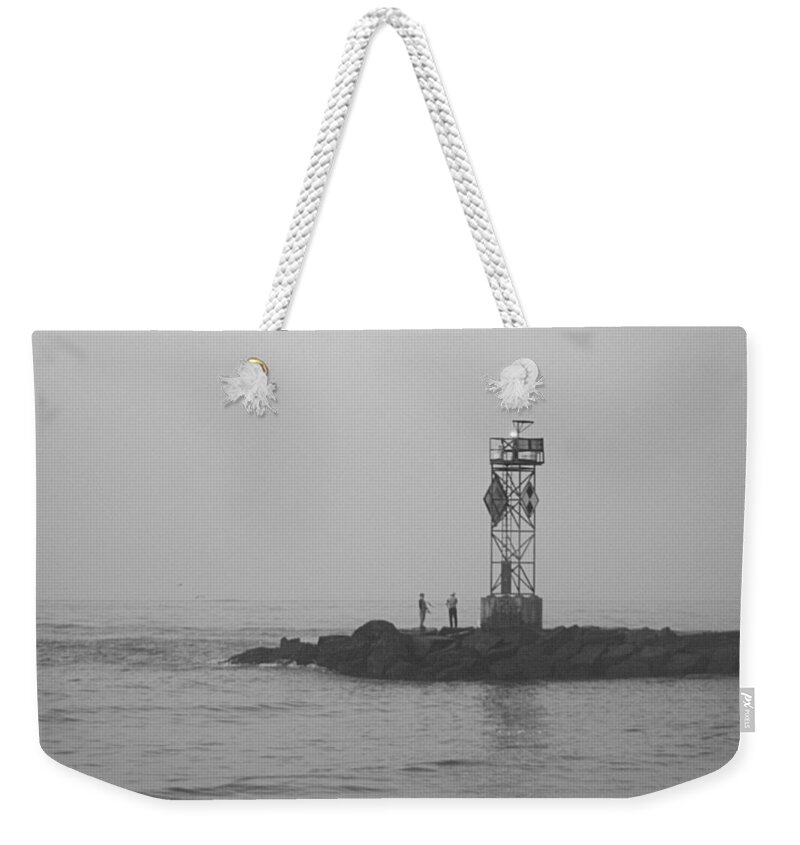 Water Weekender Tote Bag featuring the photograph Casting At The Inlet Jetty by Robert Banach