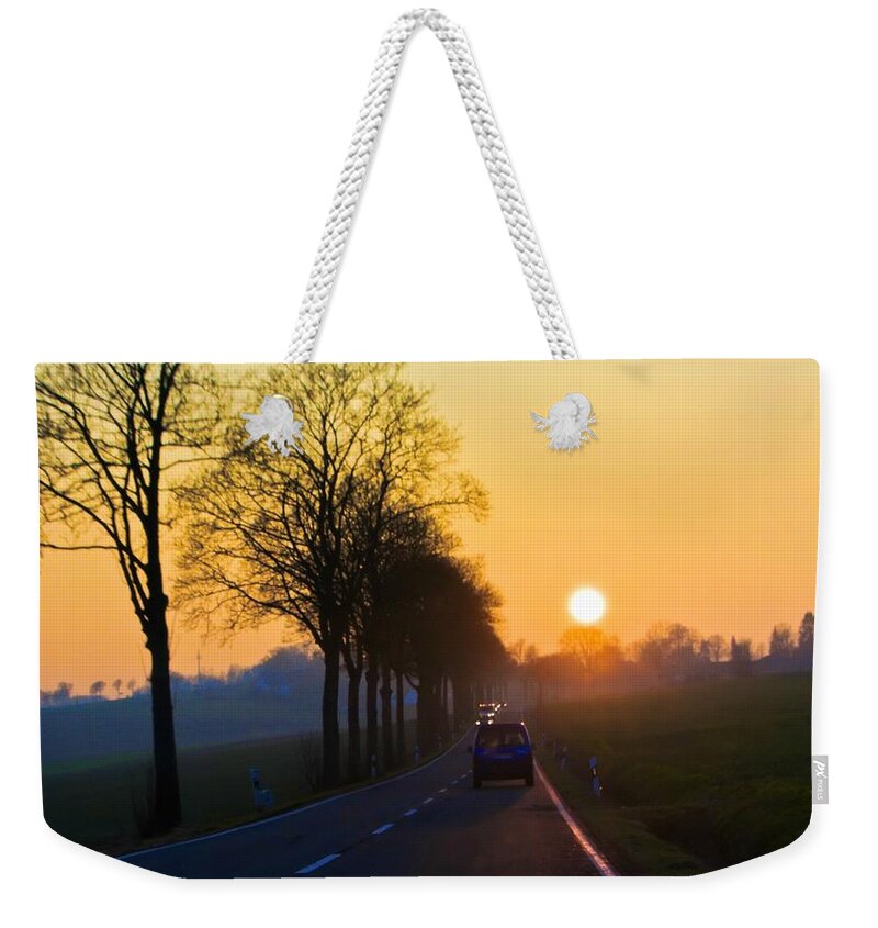 Sunset Weekender Tote Bag featuring the photograph Catching the sun by Tatiana Travelways