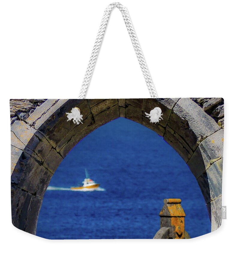 10th Century Weekender Tote Bag featuring the photograph Celtic Cross and Fishing Vessel from Isle of Inisheer by James Truett