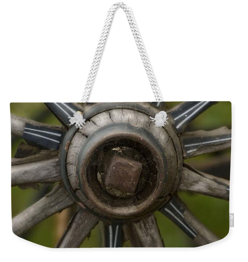 Wagon Wheel Weekender Tote Bag featuring the photograph Center of the West by Amanda Smith
