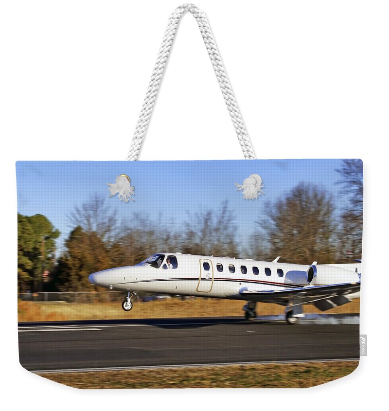 Cessna Weekender Tote Bag featuring the photograph Cessna Citation Touchdown by Jason Politte