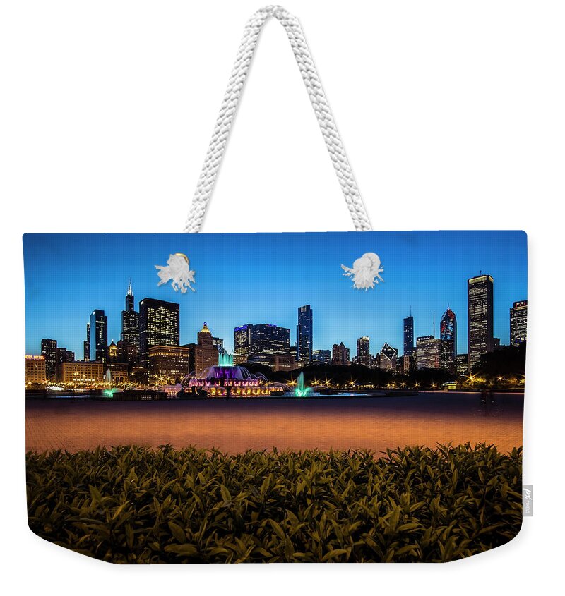 Clarence Buckingham Fountain Weekender Tote Bag featuring the photograph Chicago's Buckingham Fountain at dusk by Sven Brogren