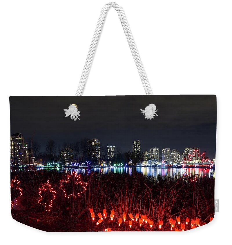 Christmas Weekender Tote Bag featuring the photograph Christmas Lights at Lafarge Lake in City of Coquitlam by David Gn