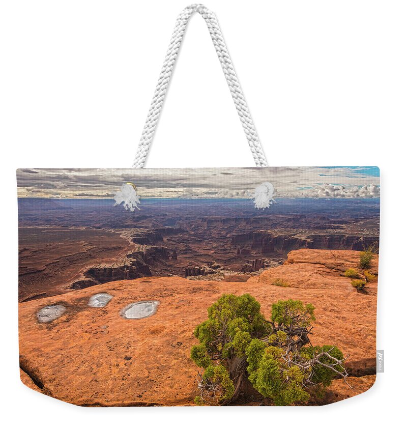 Canyonlands National Park Weekender Tote Bag featuring the photograph Clouds Junipers And Potholes by Angelo Marcialis