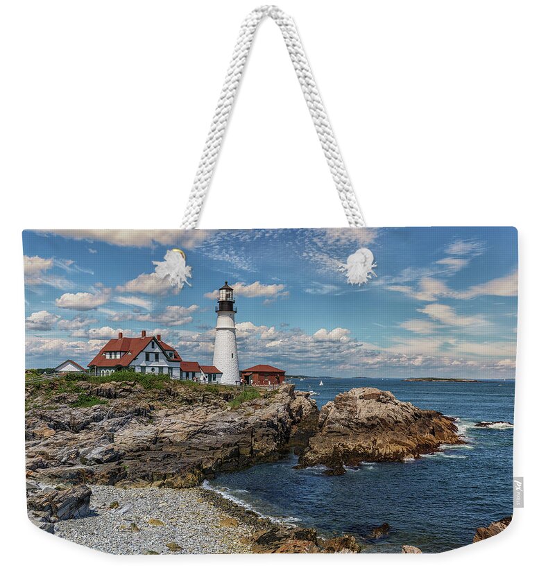 Clouds Over Portland Head Lighthouse Weekender Tote Bag featuring the photograph Clouds over Portland Head Lighthouse by Brian MacLean