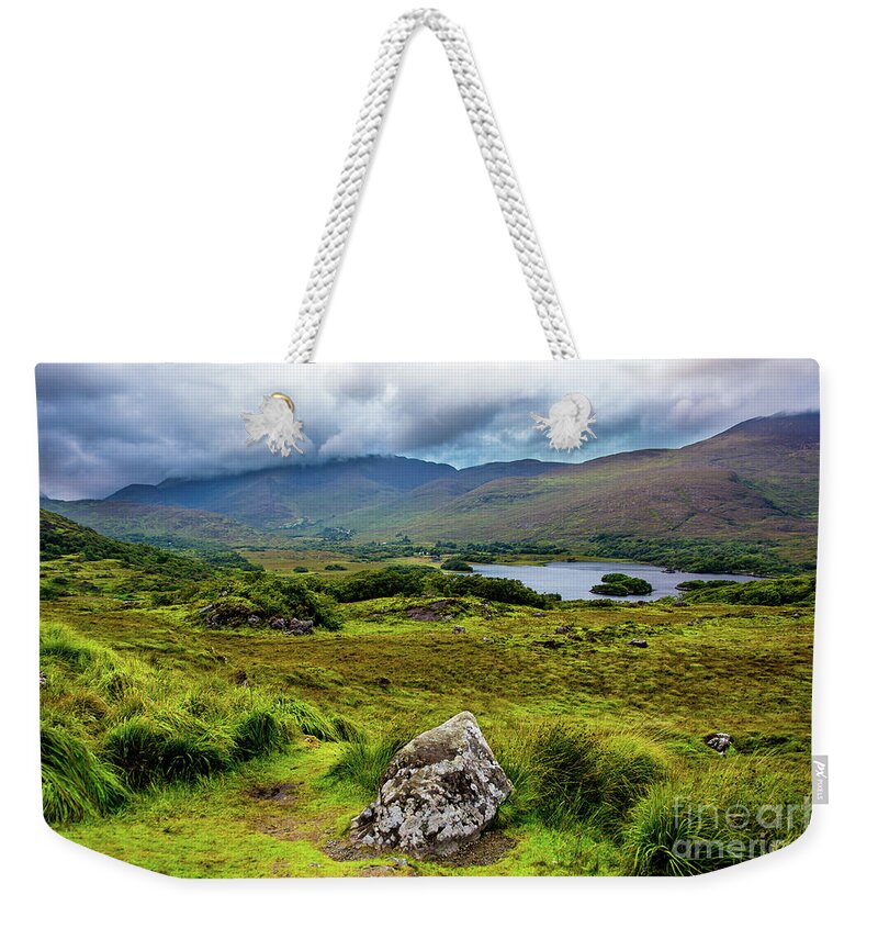 Ireland Weekender Tote Bag featuring the photograph Cloudy Hills and Lake in Ireland by Andreas Berthold