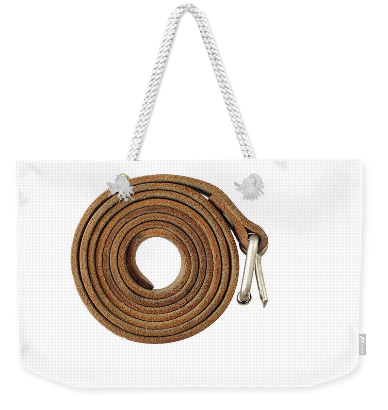 Coiled Weekender Tote Bag featuring the photograph Coiled leather belt on a white background by Michal Boubin