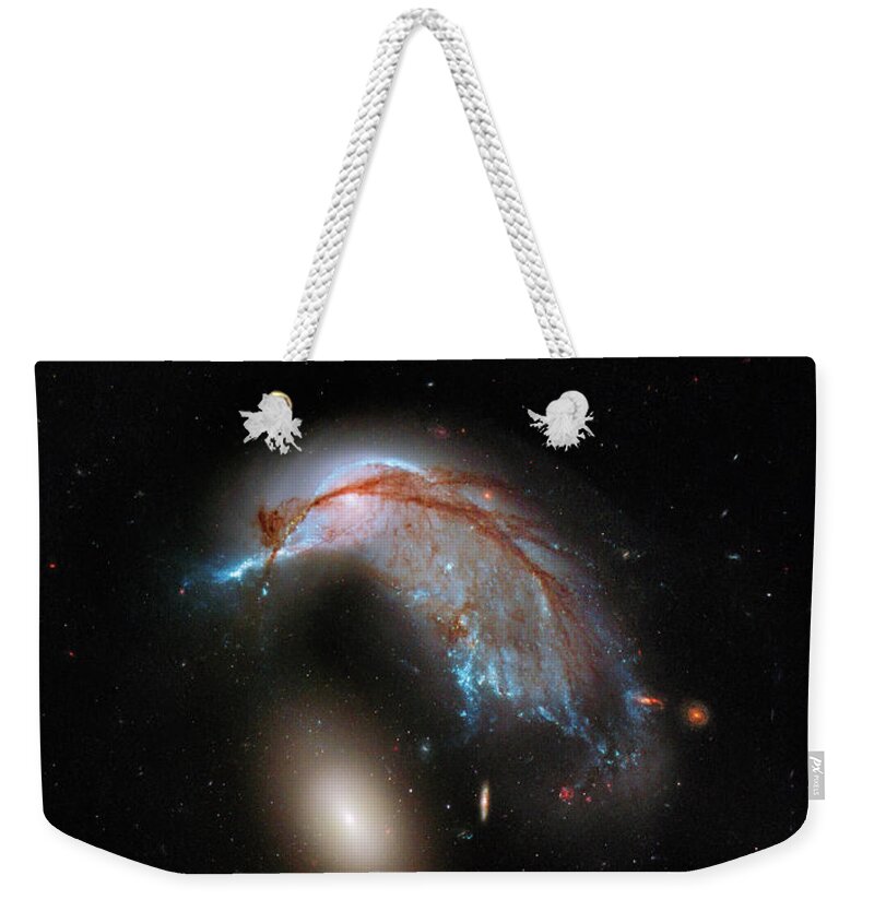 Cosmos Weekender Tote Bag featuring the photograph Colliding Galaxy by Marco Oliveira