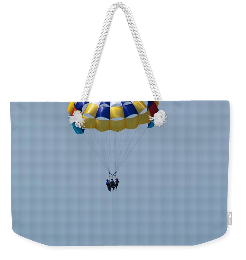 Parasailing Weekender Tote Bag featuring the photograph Colorful Parasailing by Kathy Clark