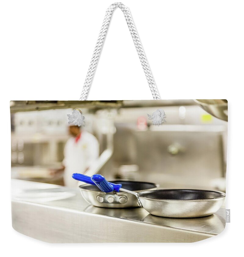 Kitchen Weekender Tote Bag featuring the photograph Commercial Pans with Chef in Background by Darryl Brooks