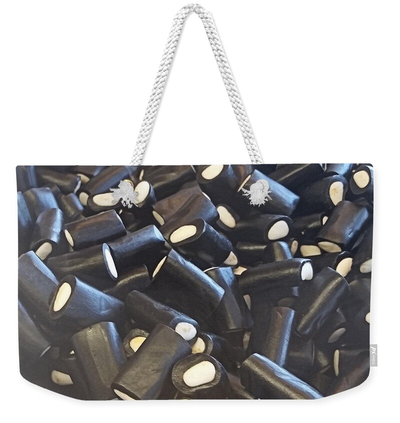 Licorice Weekender Tote Bag featuring the photograph Creme Filled Black Licorice by Robert Banach
