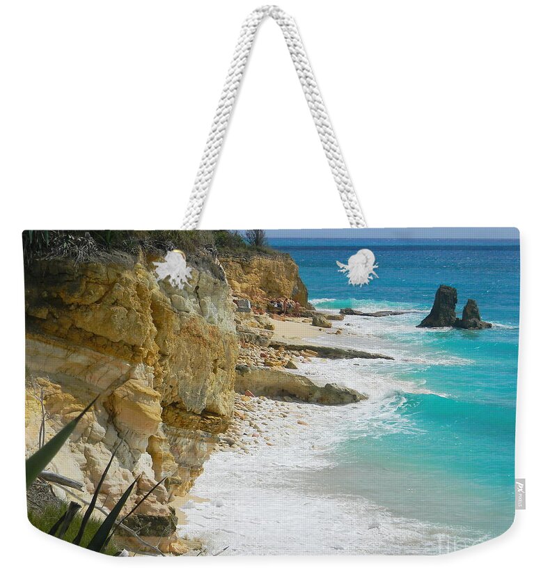 Seaside Rock Cliff Looms Above The Beach As A Turquoise Wave Washes The Unseen Sand And Is Replaced By Another . Weekender Tote Bag featuring the photograph Cupecoy beach Wave 3 by Priscilla Batzell Expressionist Art Studio Gallery