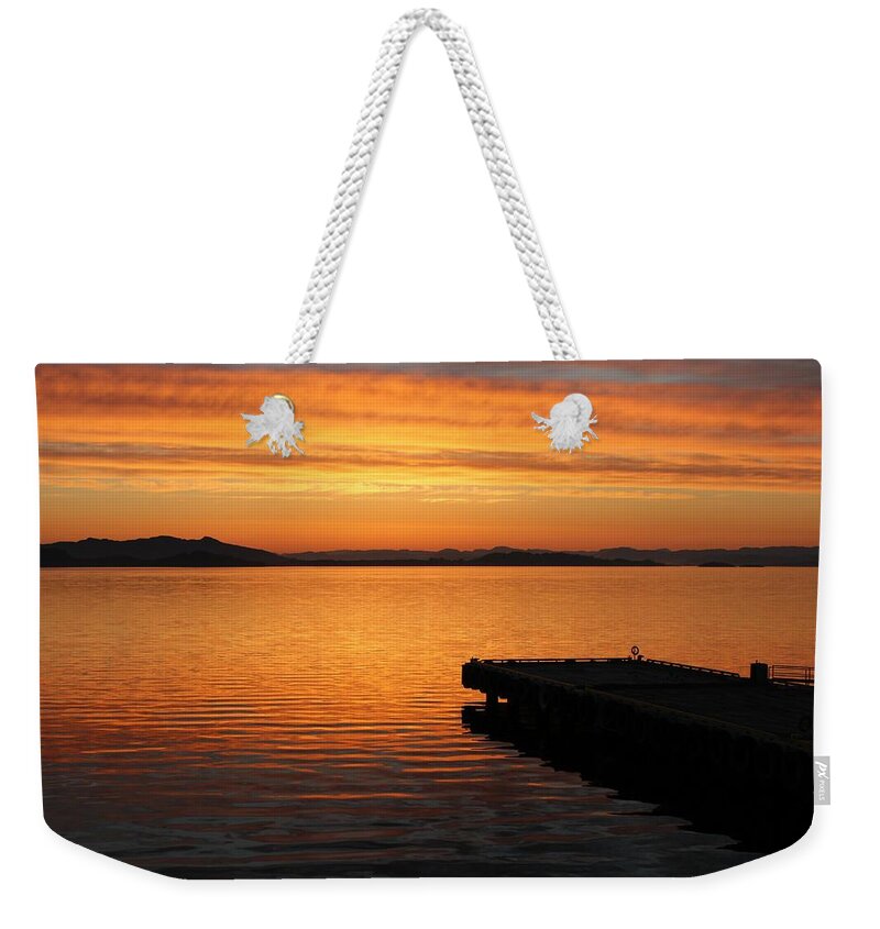Dawn Weekender Tote Bag featuring the photograph Dawn on the water at Dusavik by Charles and Melisa Morrison