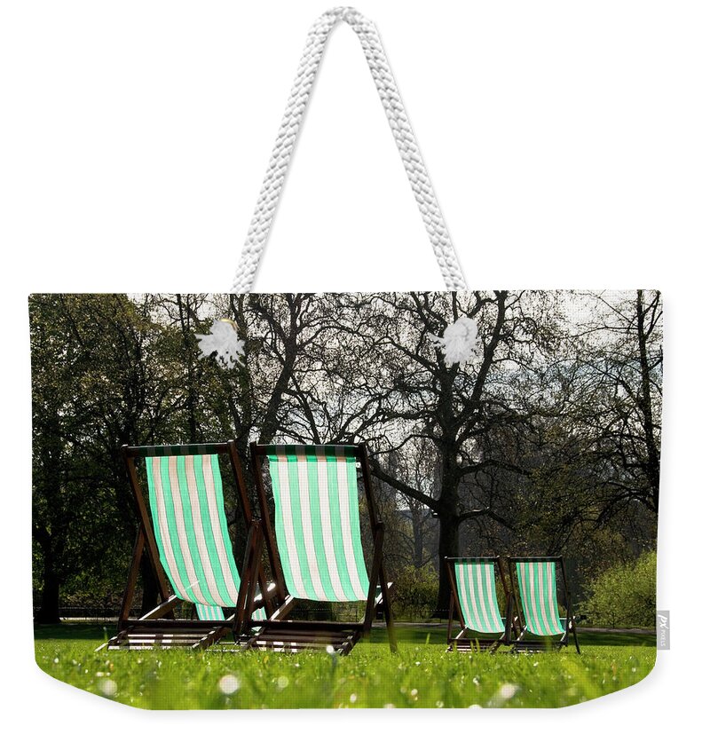 Garden Weekender Tote Bag featuring the photograph Deck chairs in a park by Dutourdumonde Photography