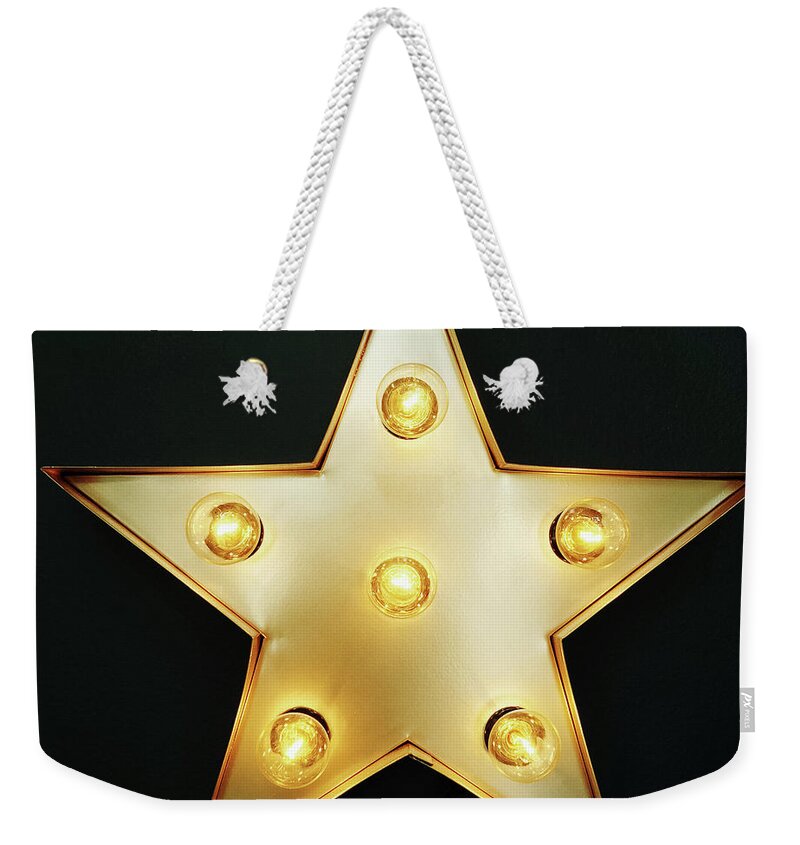Star Weekender Tote Bag featuring the photograph Decorative star with light bulbs by GoodMood Art