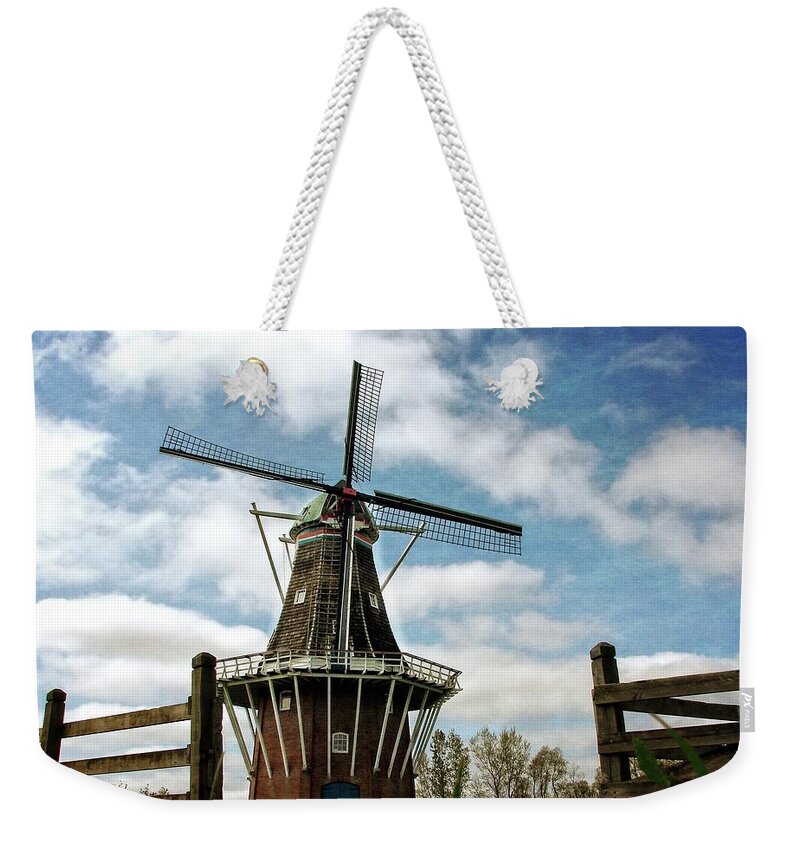 Dezwaan Weekender Tote Bag featuring the photograph DeZwaan Windmill with Fence and Clouds by Michelle Calkins