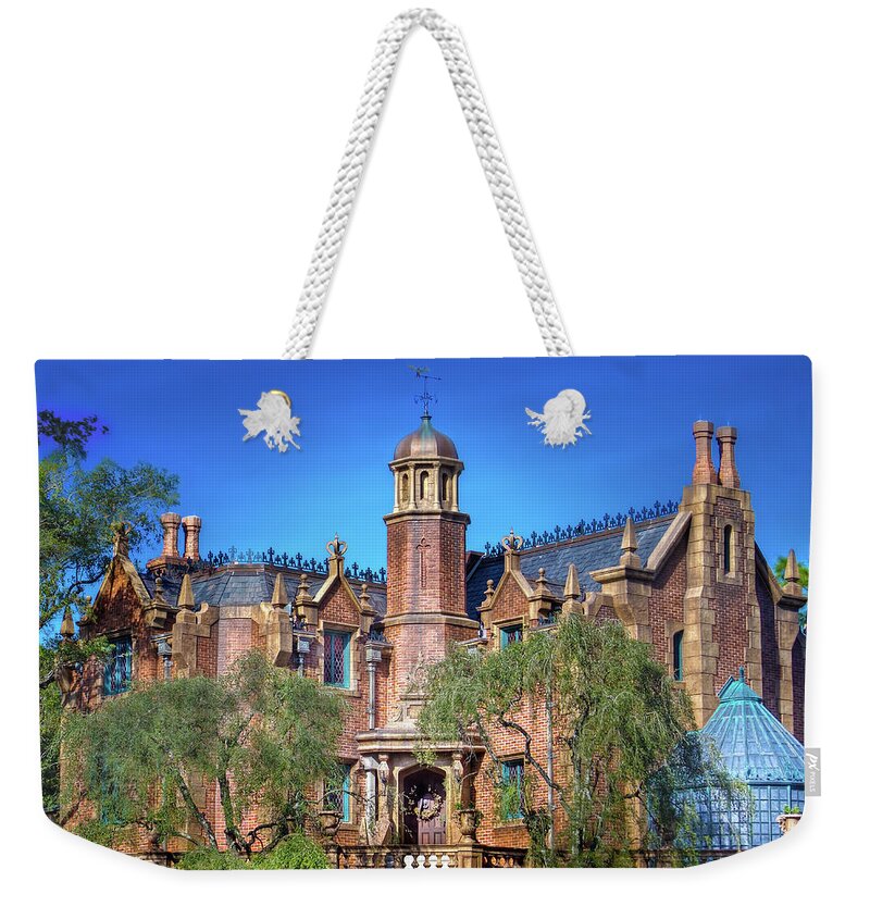 Magic Kingdom Weekender Tote Bag featuring the photograph Disney World Haunted Mansion by Mark Andrew Thomas