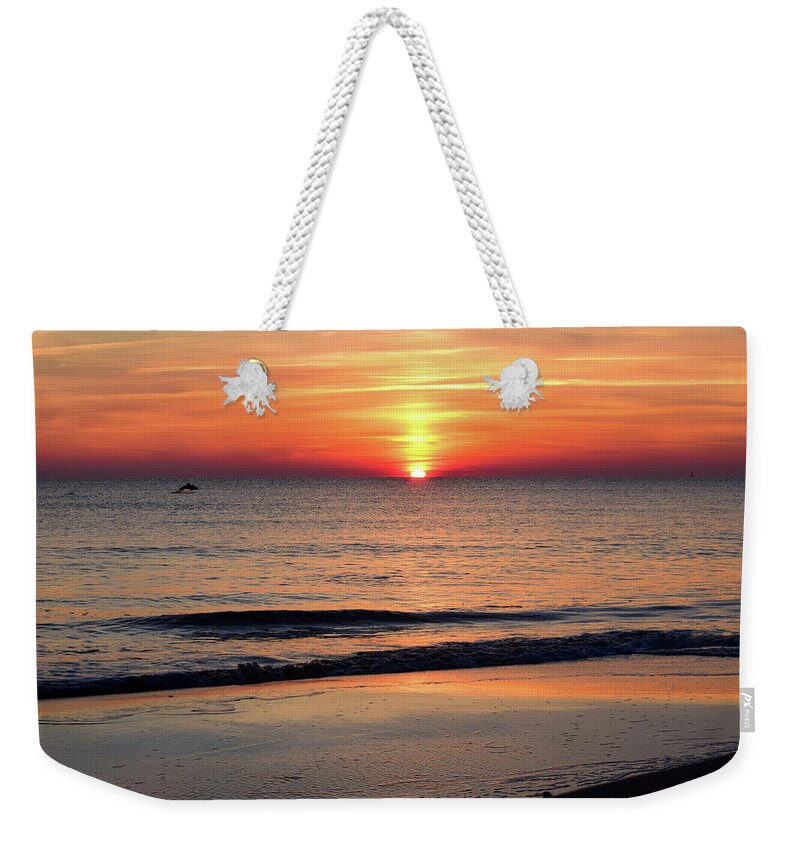Dolphin Weekender Tote Bag featuring the photograph Dolphin Jumping in the Sunrise by Nicole Lloyd