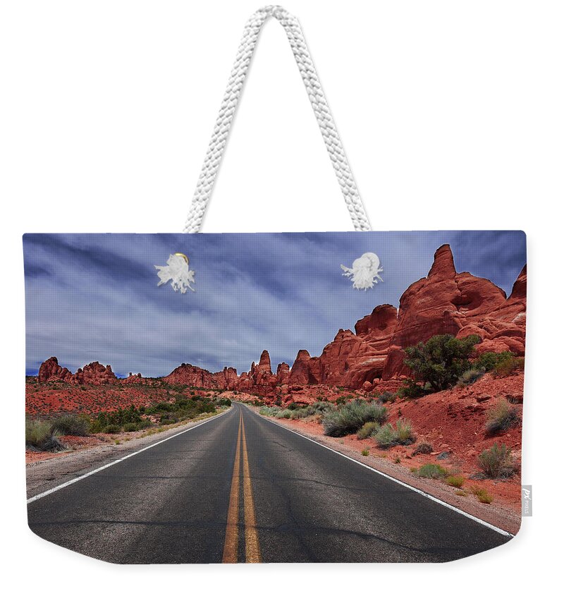 Arches Weekender Tote Bag featuring the photograph Down the Open Road by Renee Hardison