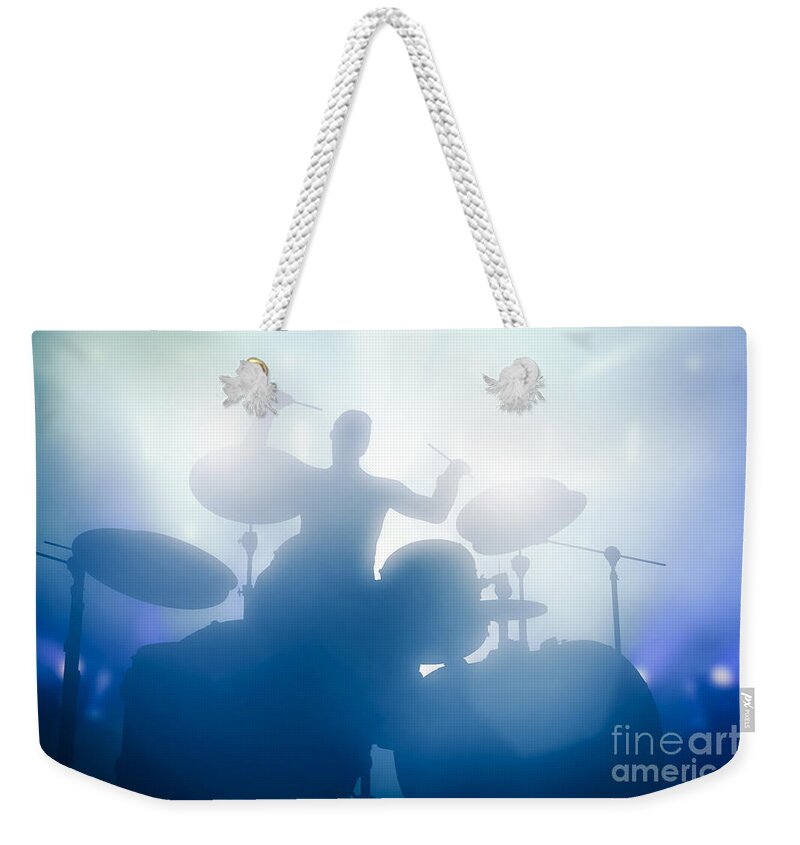 Drums Weekender Tote Bag featuring the photograph Drummer playing on drums on music concert. Club lights by Michal Bednarek